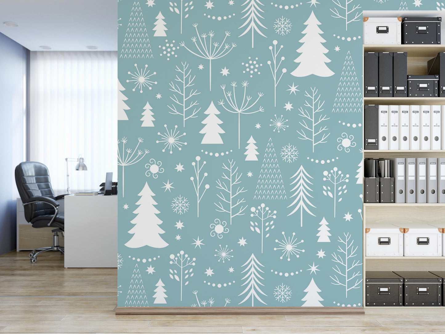 a modern office space with a large wall mural depicting a winter landscape with trees, snowflakes, and other snow-themed elements in white and light blue colors. The office has a desk, chair, and bookshelves filled with various books and binders.