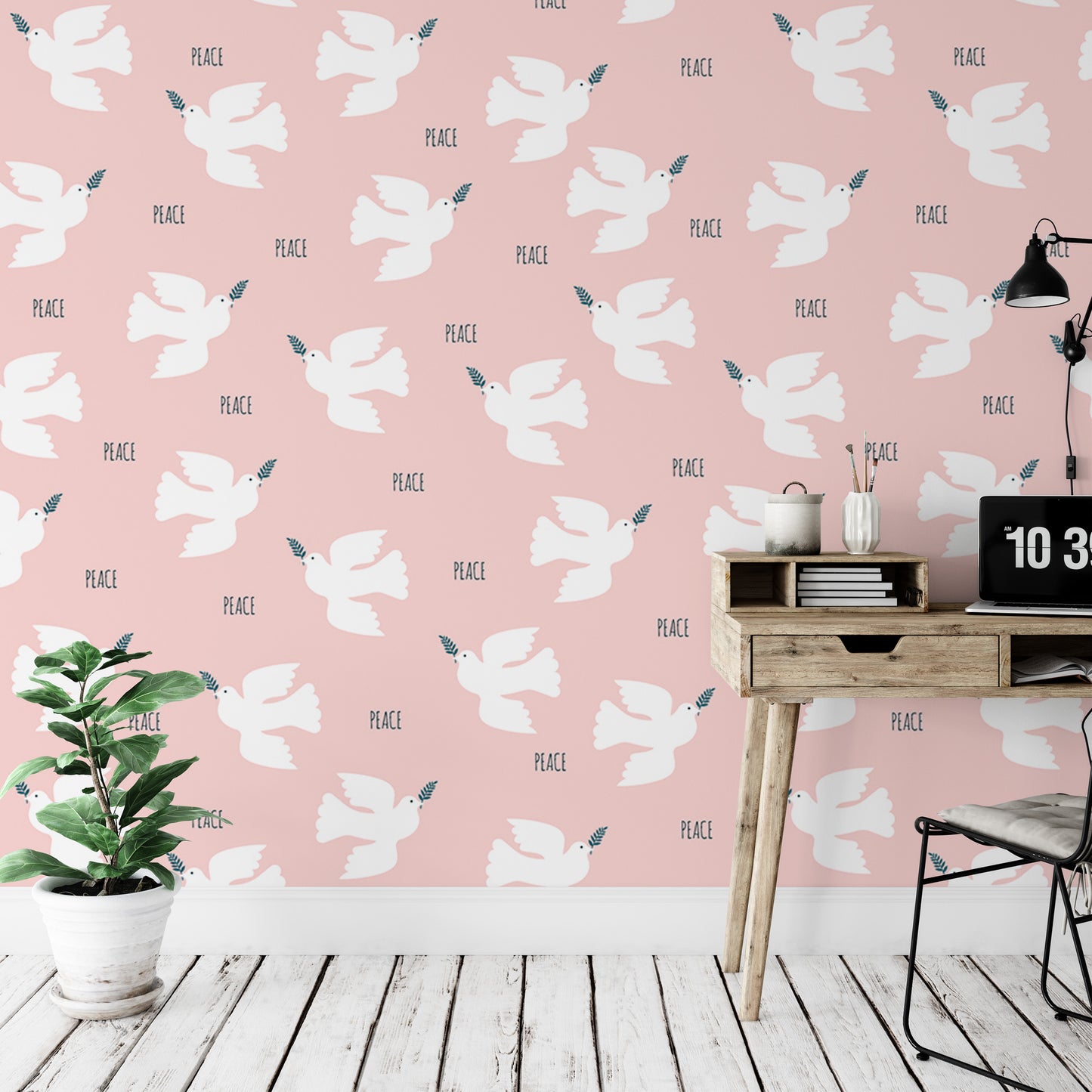 a pink wall with a repeating pattern of white doves and the word "Peace" written on it. There is a wooden desk with a laptop and a plant on it, and a chair is positioned next to the desk.