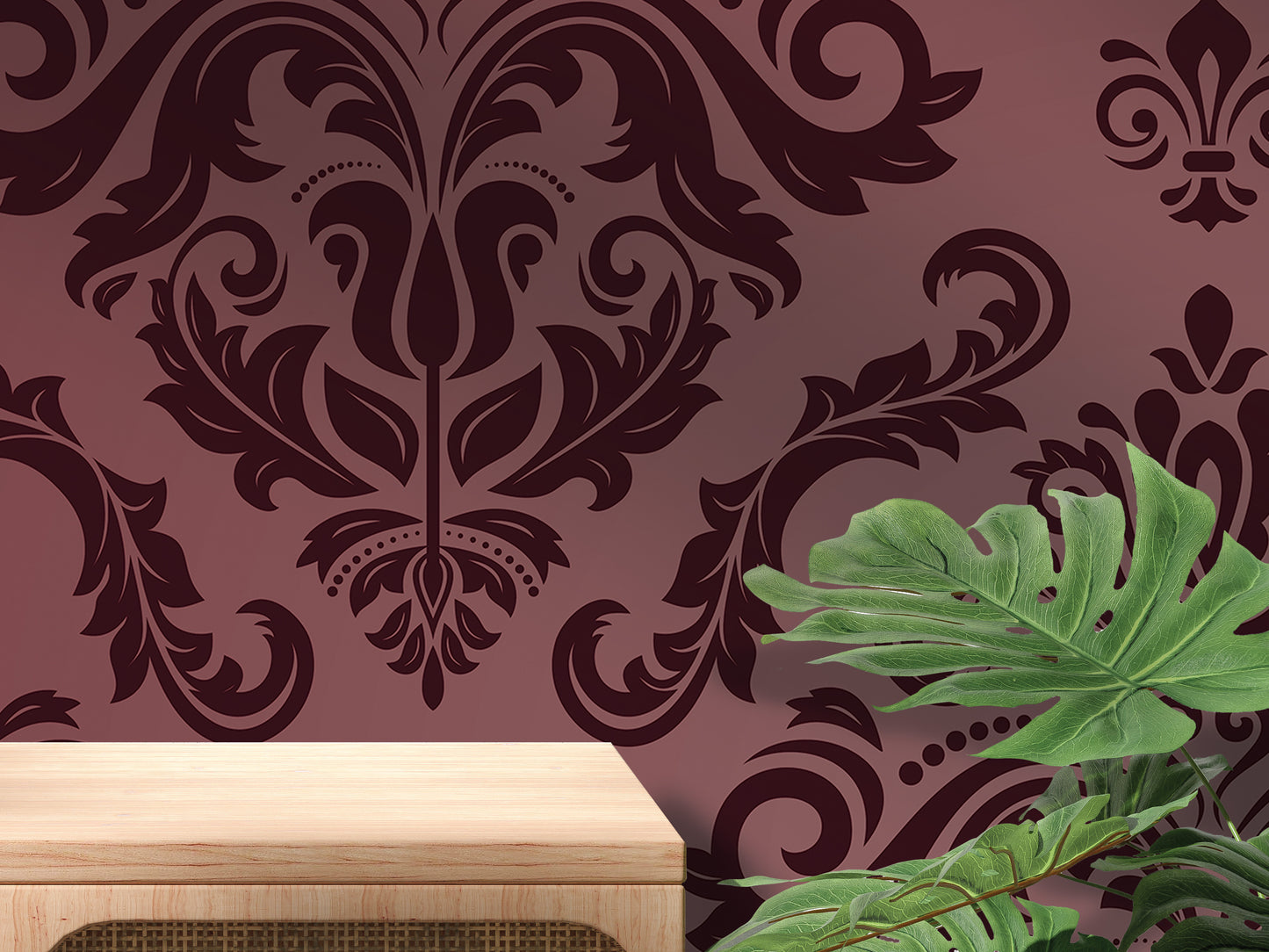 a dark purple wall with an ornate floral pattern, a wooden table, and a large green leafy plant.