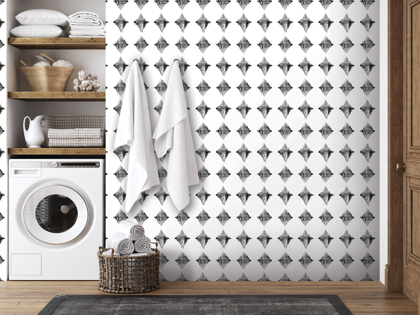 a bathroom with a black and white diamond pattern on the wall, a washing machine, and a basket of towels.