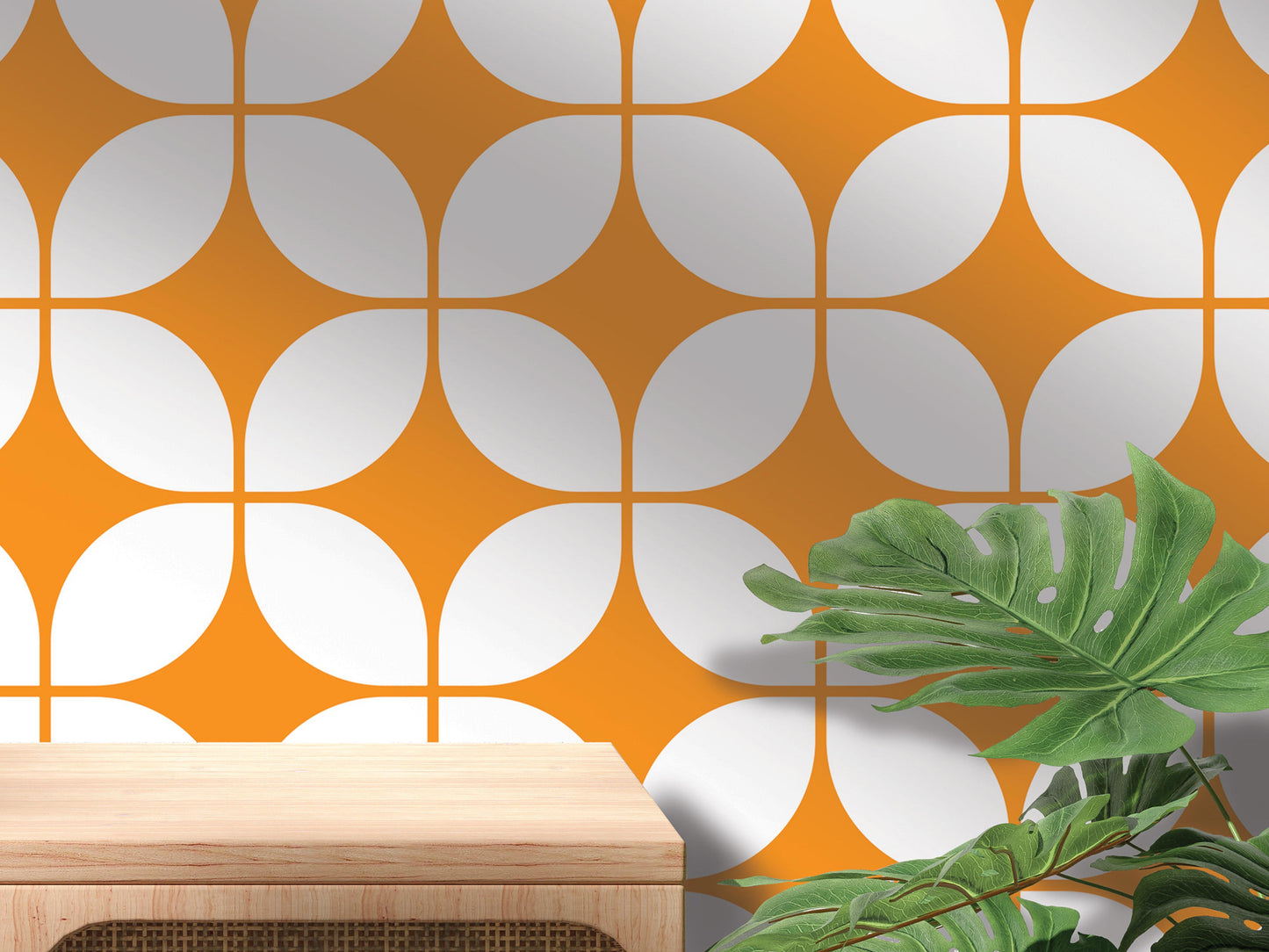 a wooden table with a plant on top, set against a wall with a repeating pattern of orange and white circles.