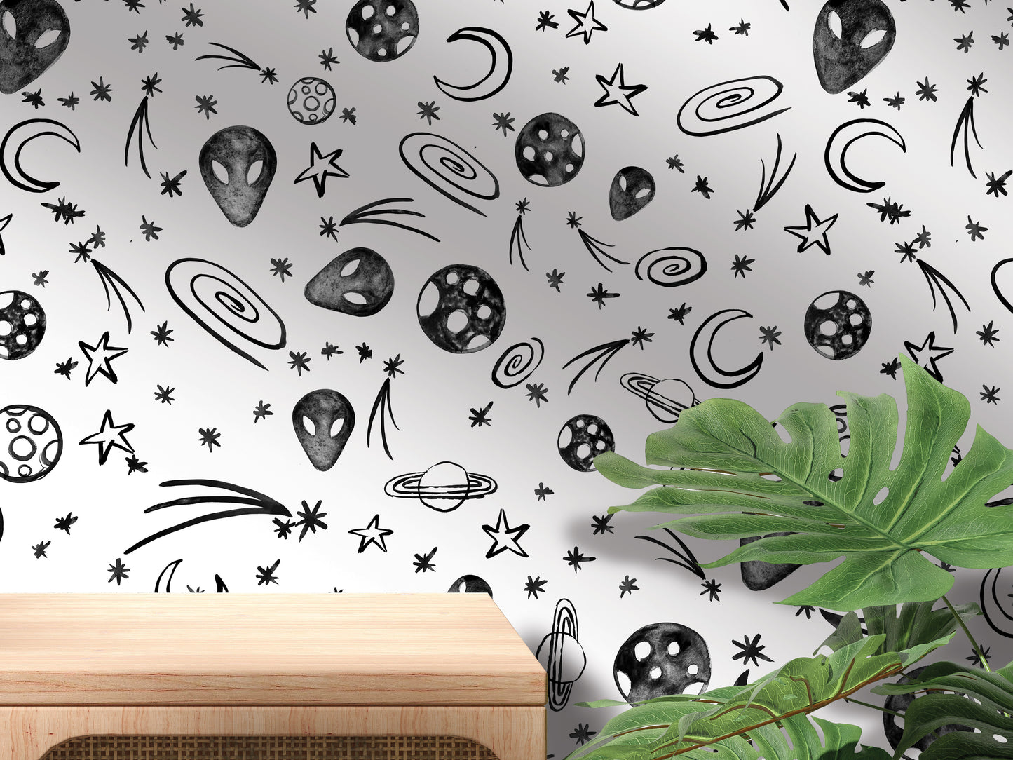 a wall with a repeating pattern of various celestial objects, including planets, stars, and comets, along with a wooden table in the foreground.