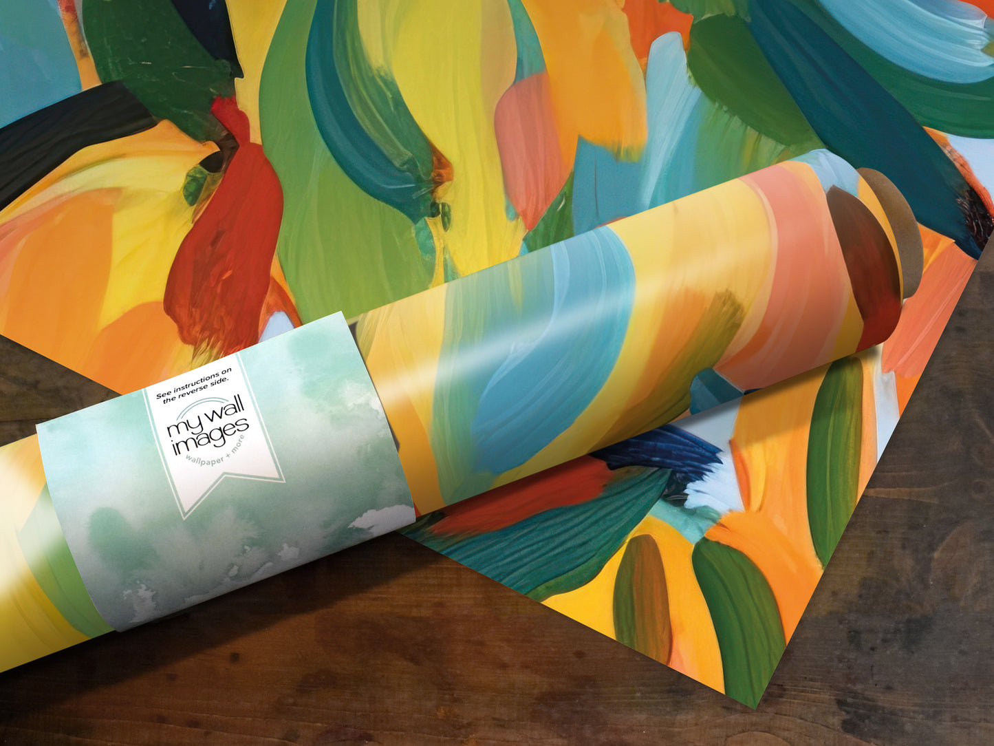 A roll of colorful, abstract wallpaper or paper with a vibrant, brushstroke-like pattern in various shades of yellow, orange, green, and blue.