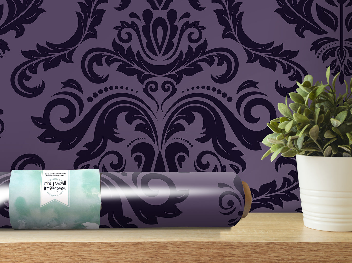a purple wallpaper with a black and white damask pattern, a potted plant, and a roll of wallpaper on a shelf.
