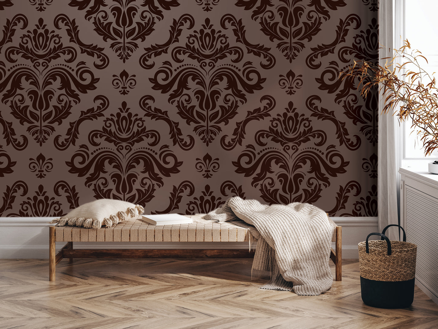 a cozy living room with a brown and white damask wallpaper, a wooden bench with a blanket and pillows, and a woven basket on the floor.