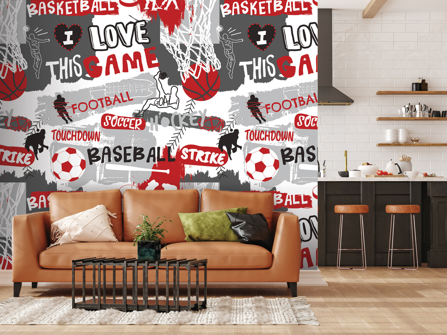 a living room with a brown leather couch, a coffee table, and a kitchen area with a counter and stools. The wall behind the couch is covered in a collage of various sports-related words and images, including basketball, soccer, football, and baseball.