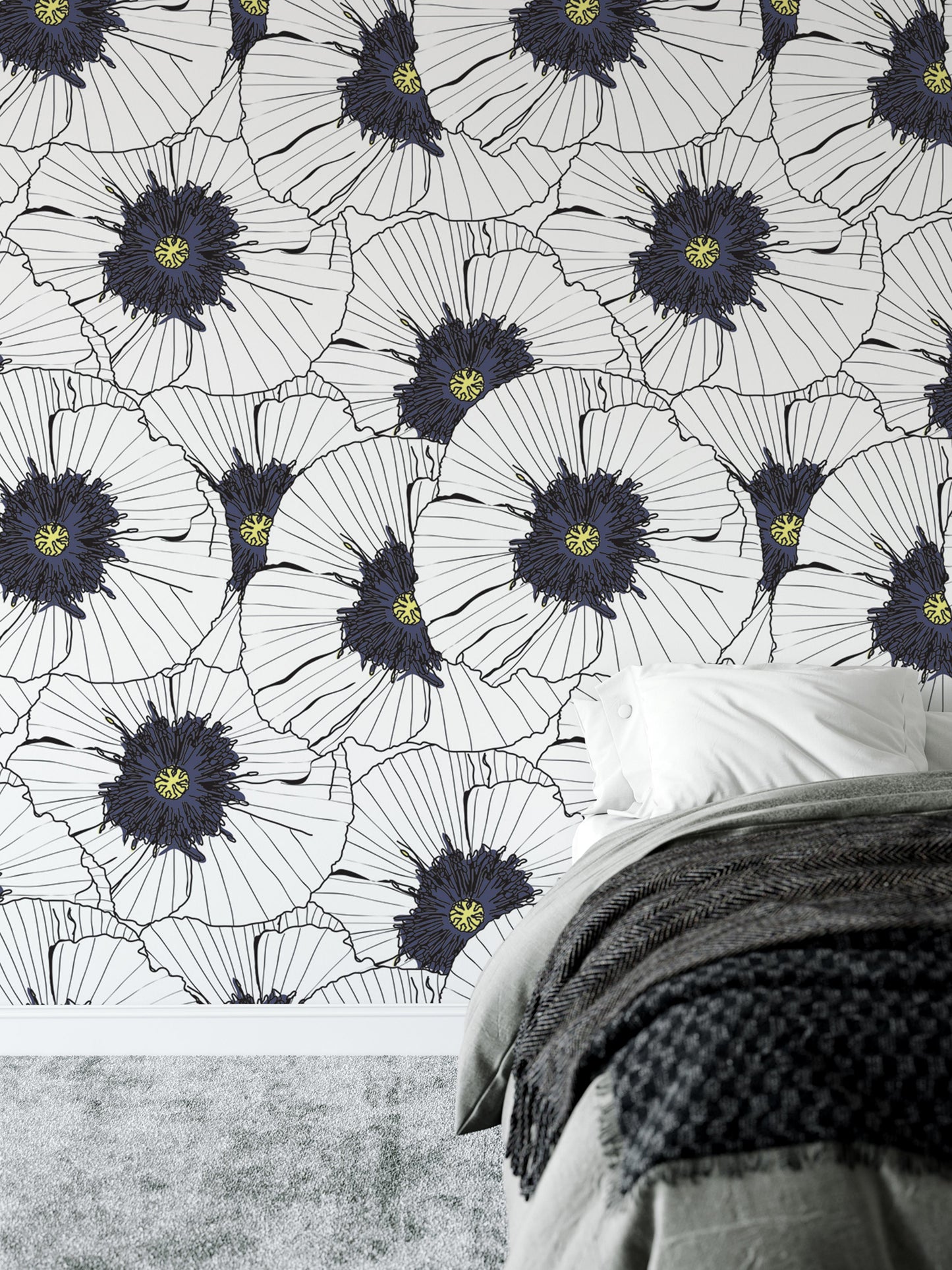 a bedroom with a bed and a wallpapered wall with a repeating pattern of white and blue flowers.