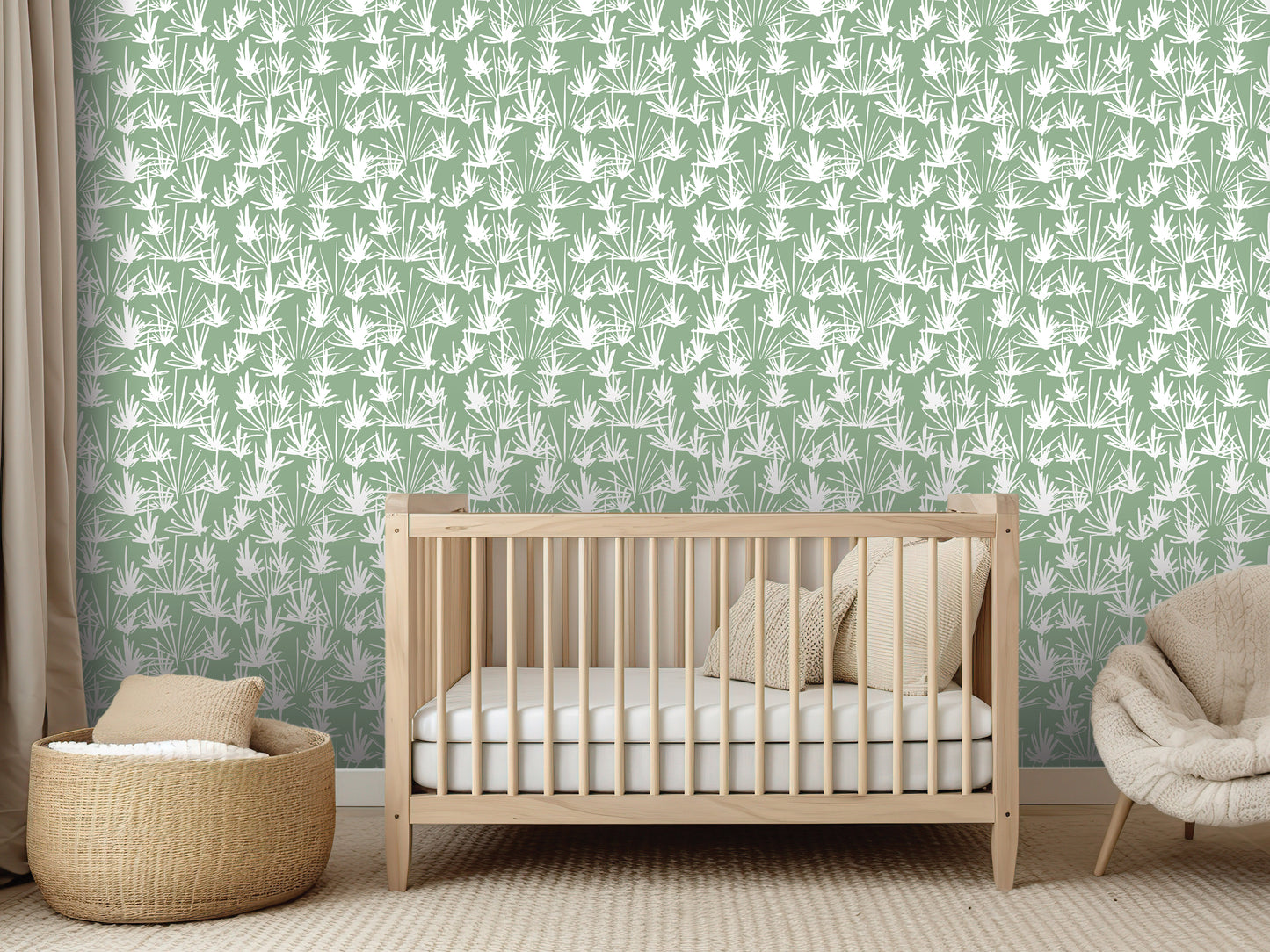 a nursery room with a wooden crib, a woven basket, and a beige chair. The walls are covered in a repeating pattern of white leaves, creating a natural and calming atmosphere.