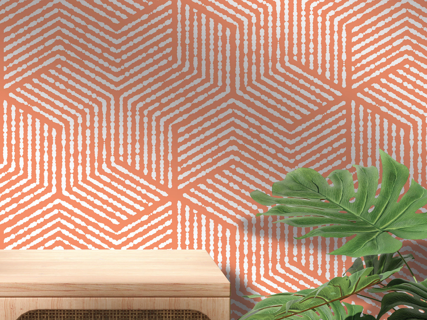 a wooden table with a plant on top of it, set against a vibrant orange and white geometric patterned wall.