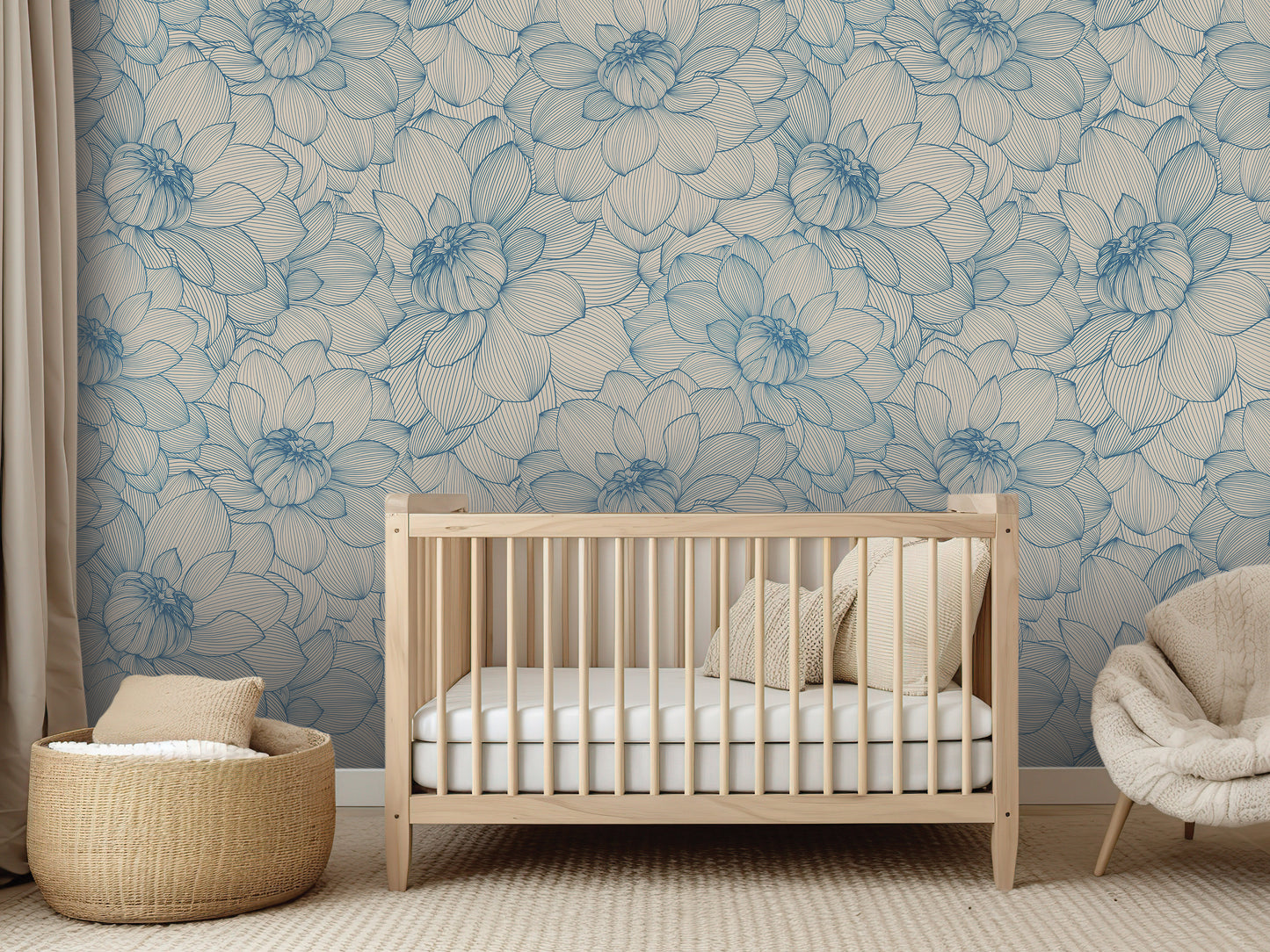 a nursery room with a wooden crib, a woven basket, and a plush chair. The room has a blue floral wallpaper on the walls, creating a serene and calming atmosphere.