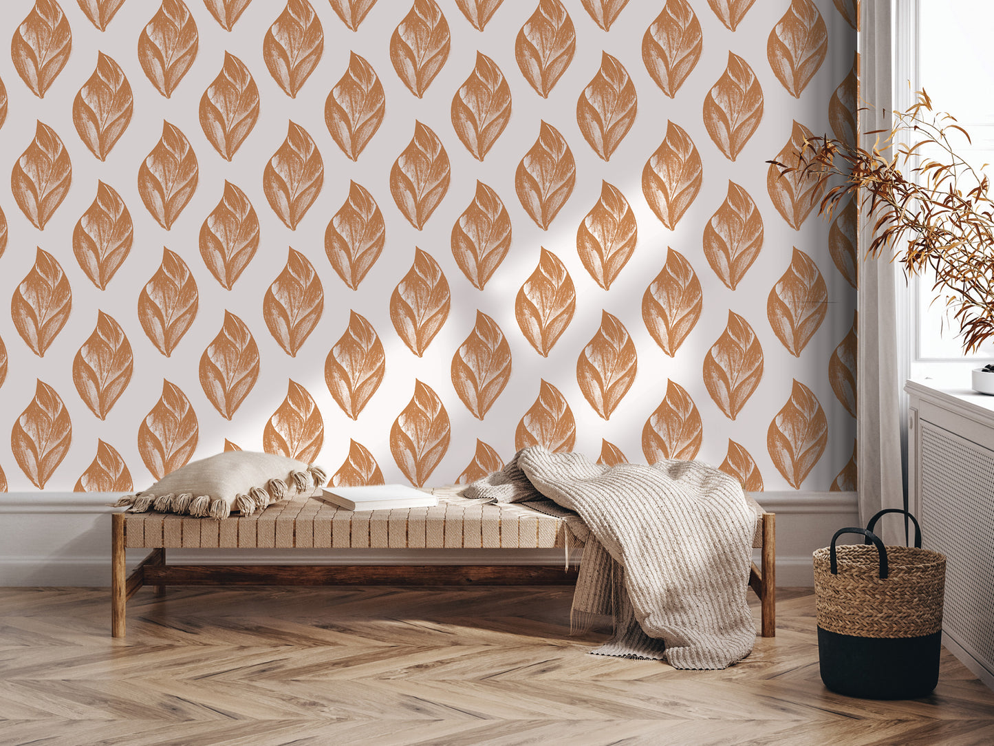 a cozy living room setting with a wooden bench, a woven basket, and a patterned wall behind it. The wall has a repeating pattern of orange leaves, creating a warm and inviting atmosphere.