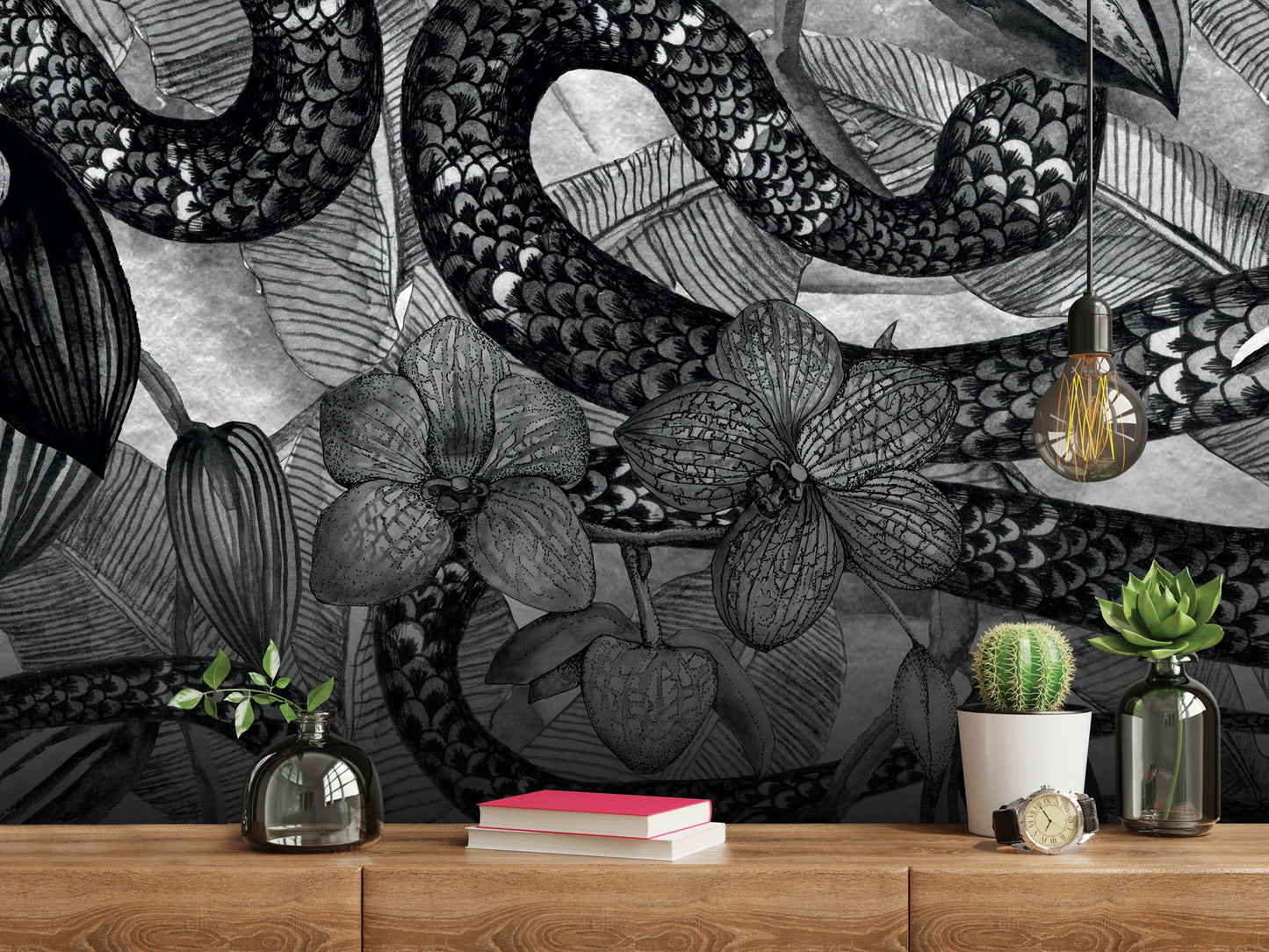 a wooden shelf with various decorative items, including a cactus plant, a book, a clock, and a vase. The shelf is set against a wall with a striking black and white mural depicting a snake and floral elements.