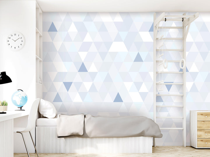 a modern bedroom with a white bed, a wooden dresser, and a geometric patterned wall.
