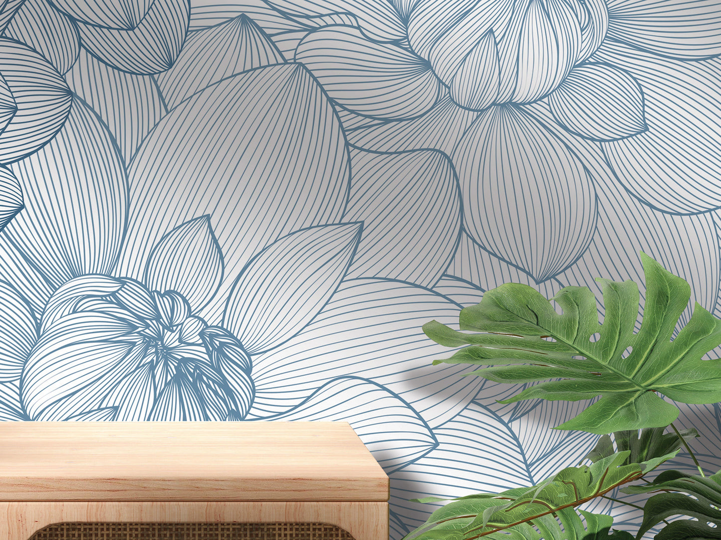 a wallpapered wall with a blue and white floral pattern, a wooden table, and some green plants.