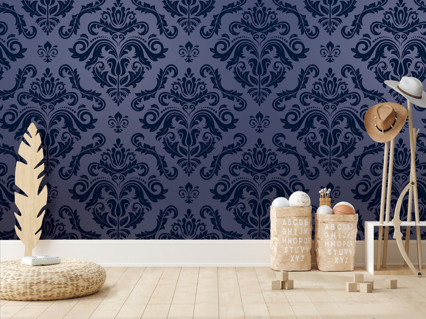 a room with a blue damask patterned wall, a wicker basket, a wooden stool, and a stack of wooden blocks.
