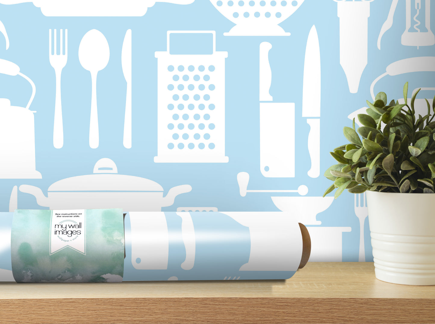 a wooden shelf with a potted plant and a roll of wallpaper with a kitchen-themed design.