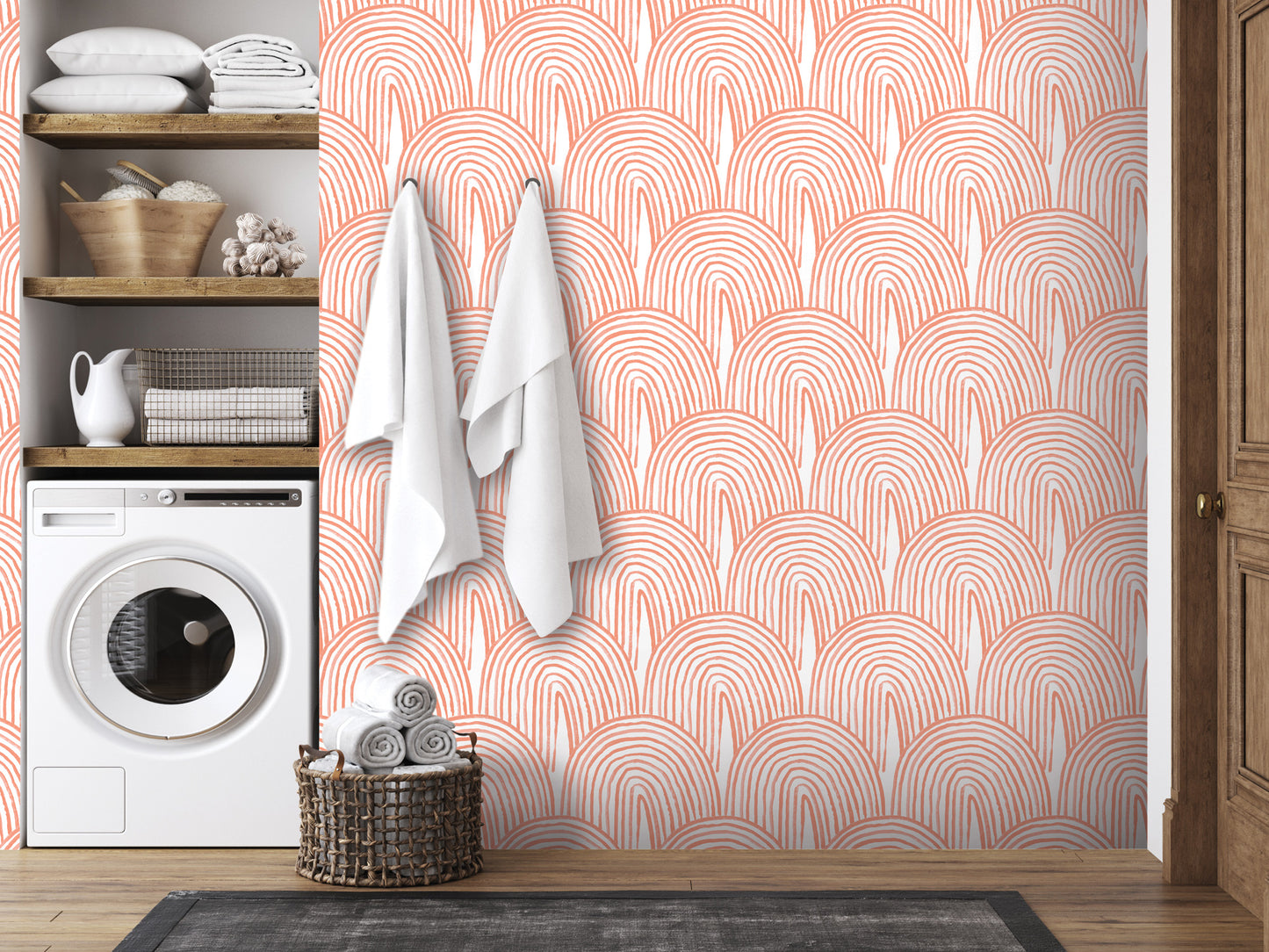 a bathroom with a white washing machine, a wooden shelf with towels and baskets, and a wall with a repeating pattern of orange and white circles.