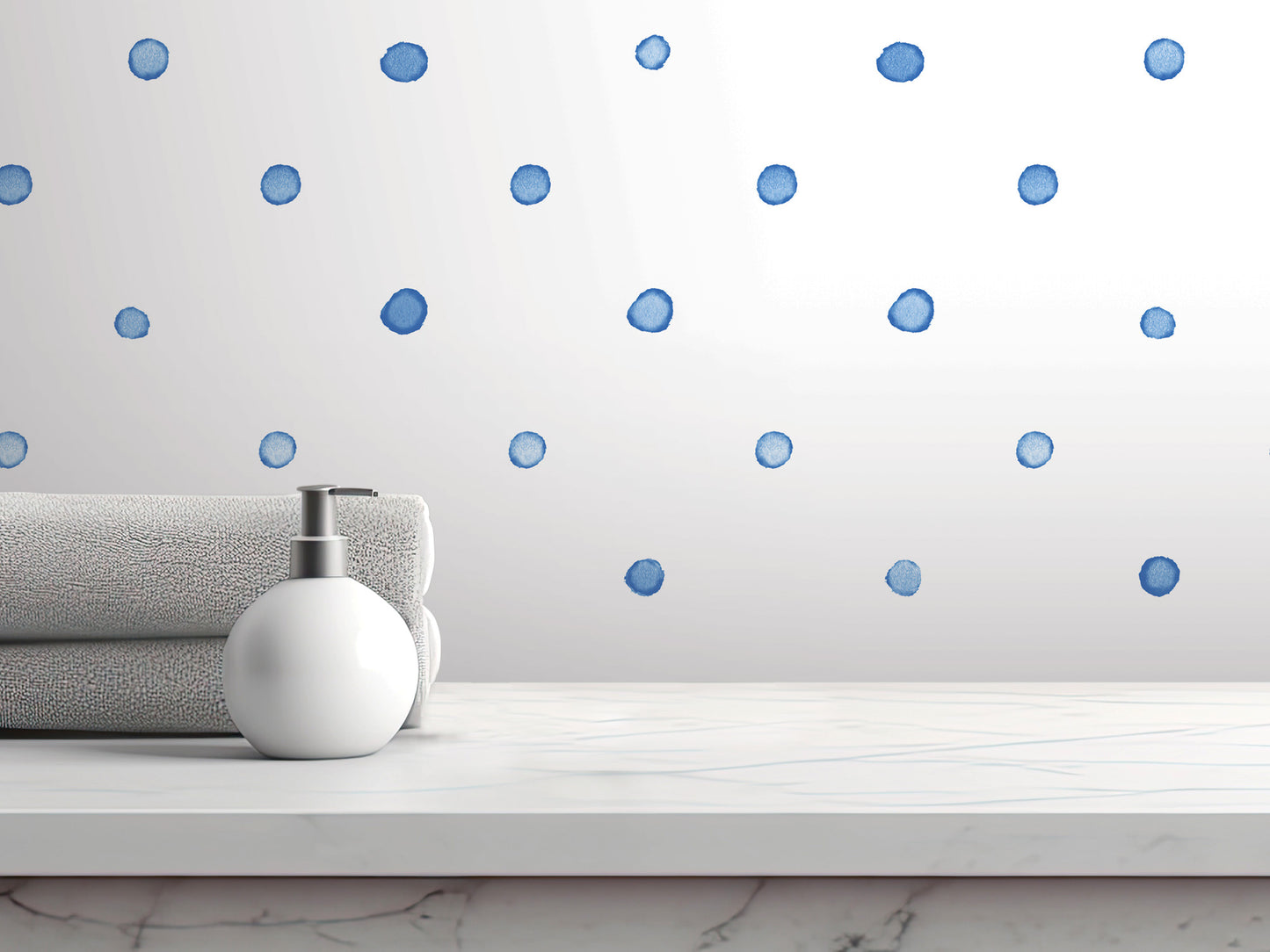 a white countertop with a white soap dispenser, a gray towel, and a white marble surface. The towel is folded and placed on the countertop, while the soap dispenser is positioned next to it. The background of the image is a white wall with blue polka dots.