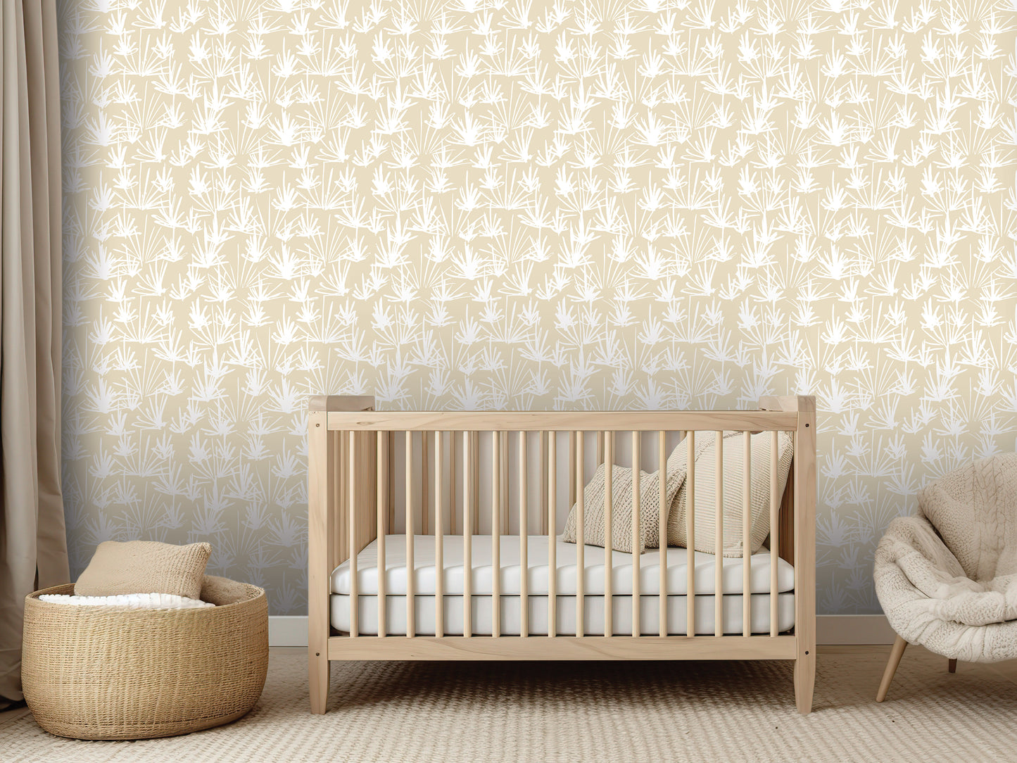 a modern nursery with a wooden crib, a woven basket, and a plush chair. The crib is positioned against a wall with a repeating pattern of white leaves, creating a serene and natural atmosphere.