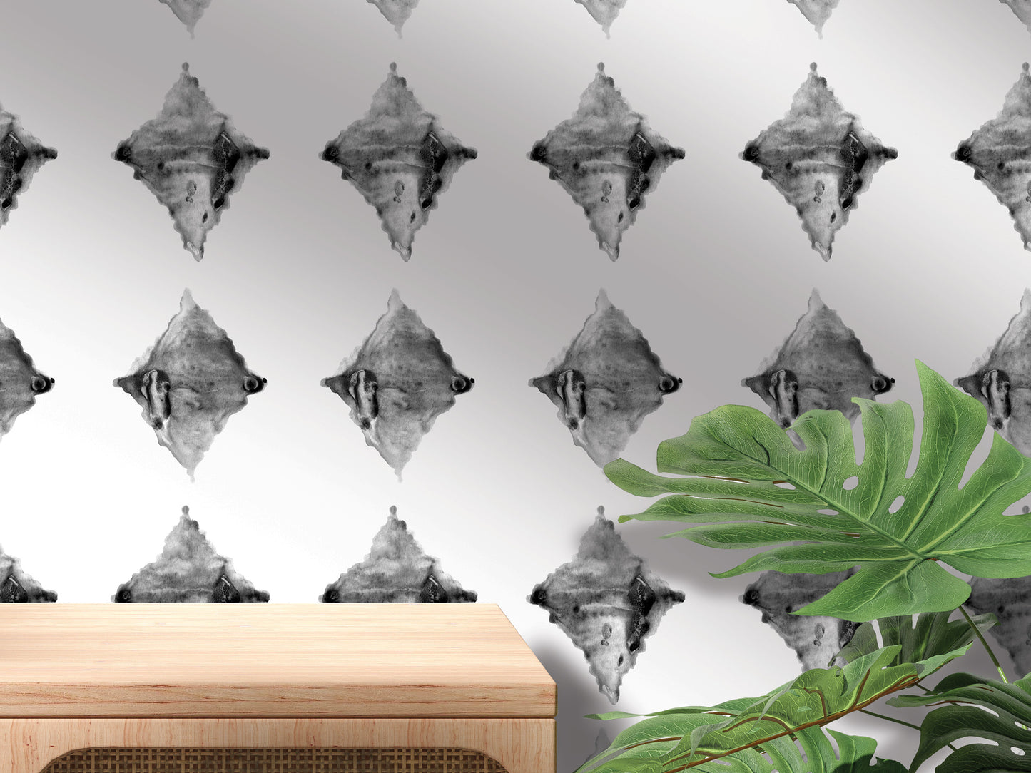a wall with a repeating pattern of black and white diamond shapes, and a wooden table is placed in front of the wall.