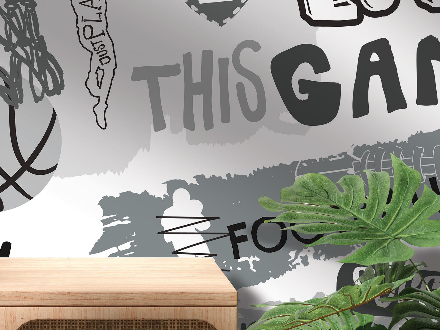 The image is a wall mural with various abstract and stylized text and shapes, including the words 'THIS GAY' and 'FOOTBALL'. The overall composition appears to be a collage of different images, with a wooden table in the foreground.