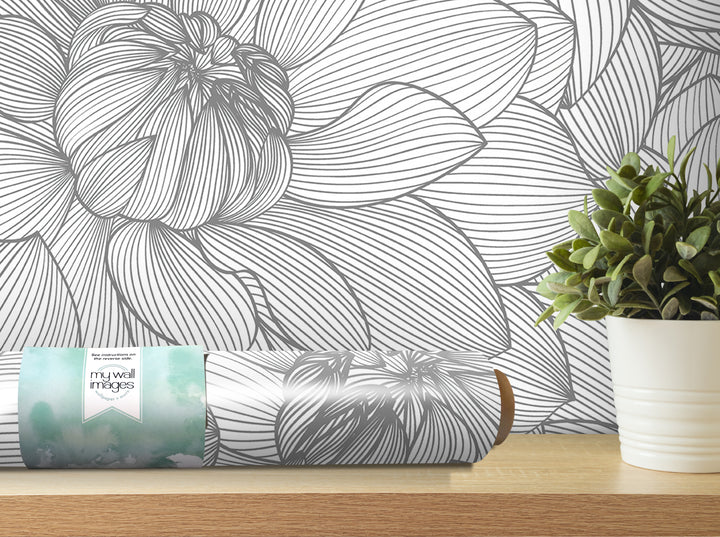 a wallpapered wall with a large, intricate floral pattern, and a potted plant placed on a shelf next to it.