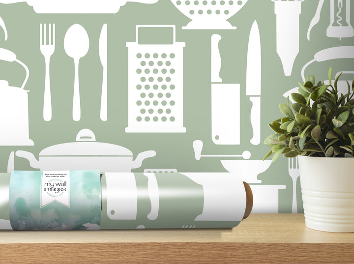 a kitchen-themed wallpaper with various kitchen utensils and appliances, such as a knife, spoon, and grater, as well as a potted plant.
