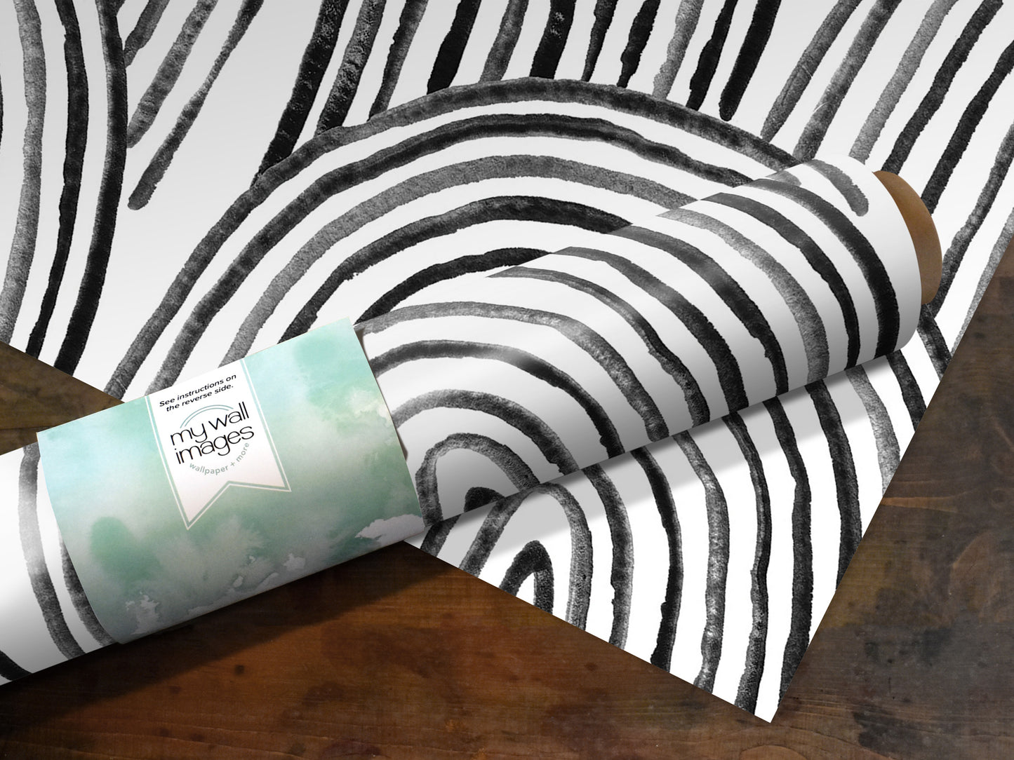 A roll of paper with a black and white striped pattern, placed on a wooden surface.