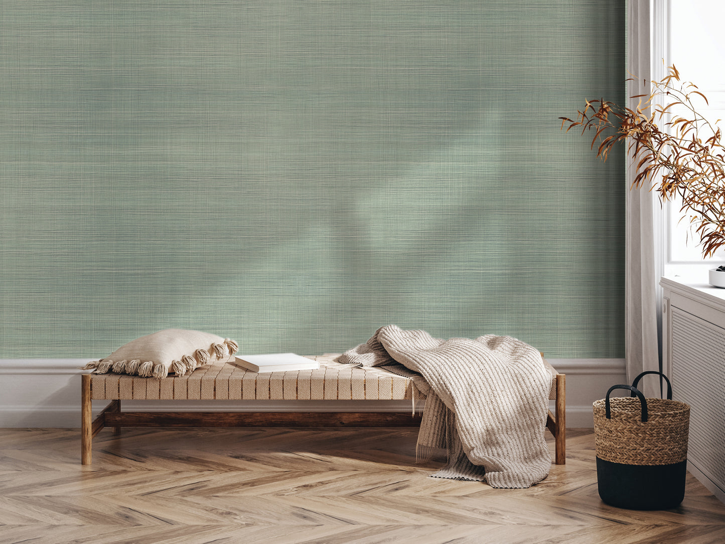 a cozy corner with a wooden bench, a woven basket, and a plant, all set against a textured green wall.