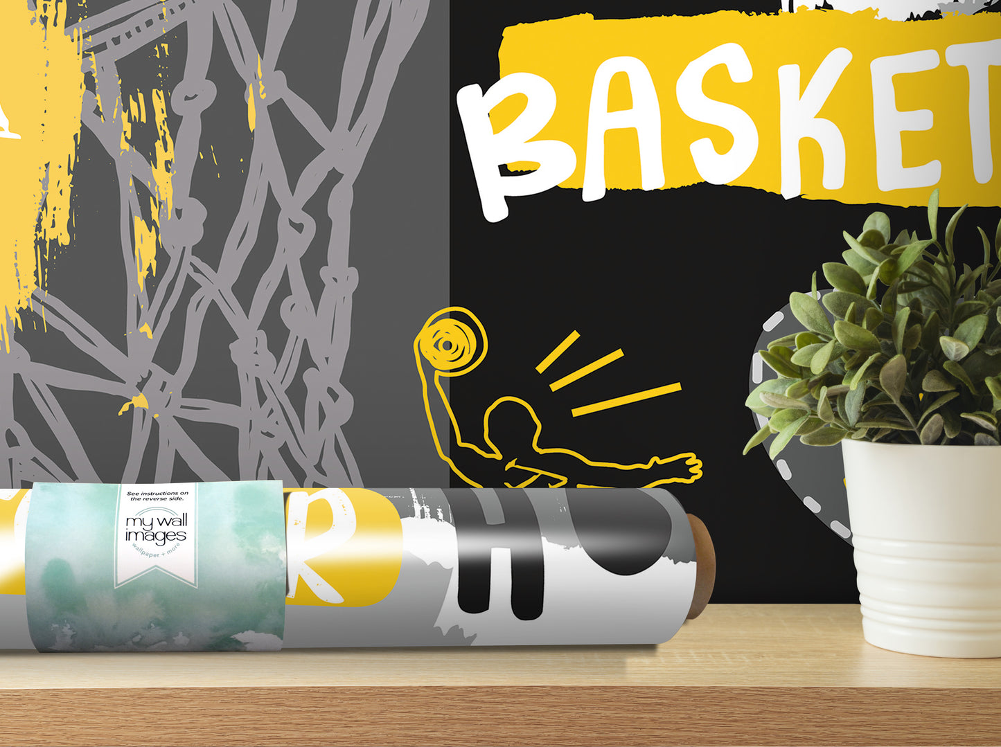 a poster with the word "Basket" written on it, along with a potted plant and a roll of wallpaper on a shelf.