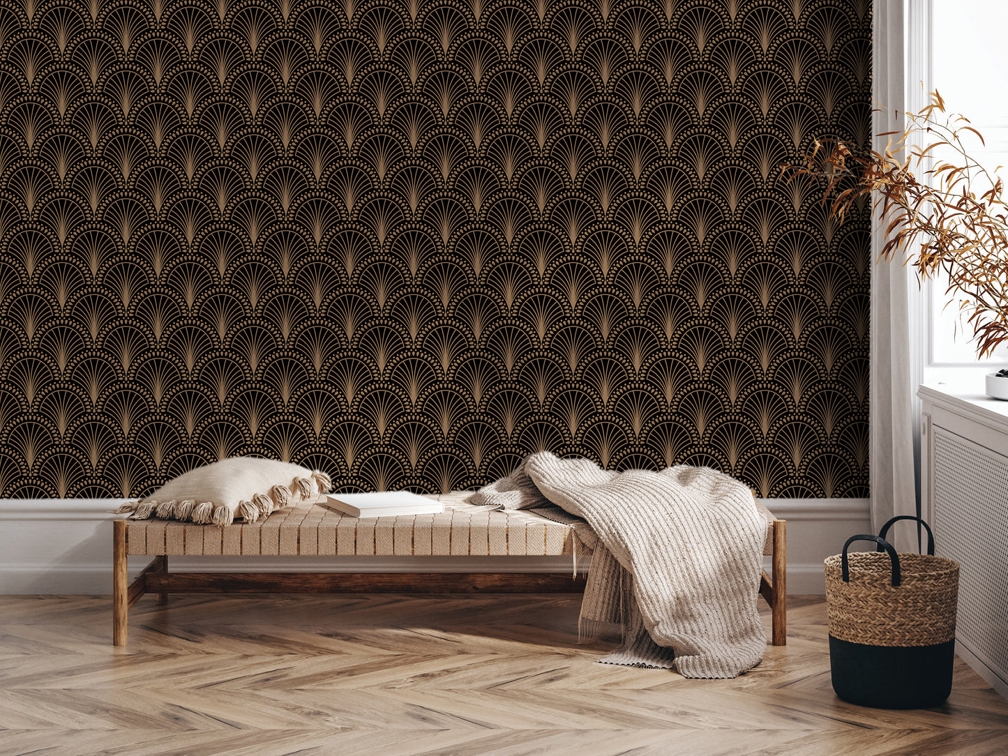 a cozy living room with a wooden floor and a bench against a wall with an Art Deco-inspired wallpaper. The bench is adorned with a white blanket and a woven basket, adding a touch of rustic charm to the space. A potted plant is also present, further enhancing the room's inviting atmosphere.