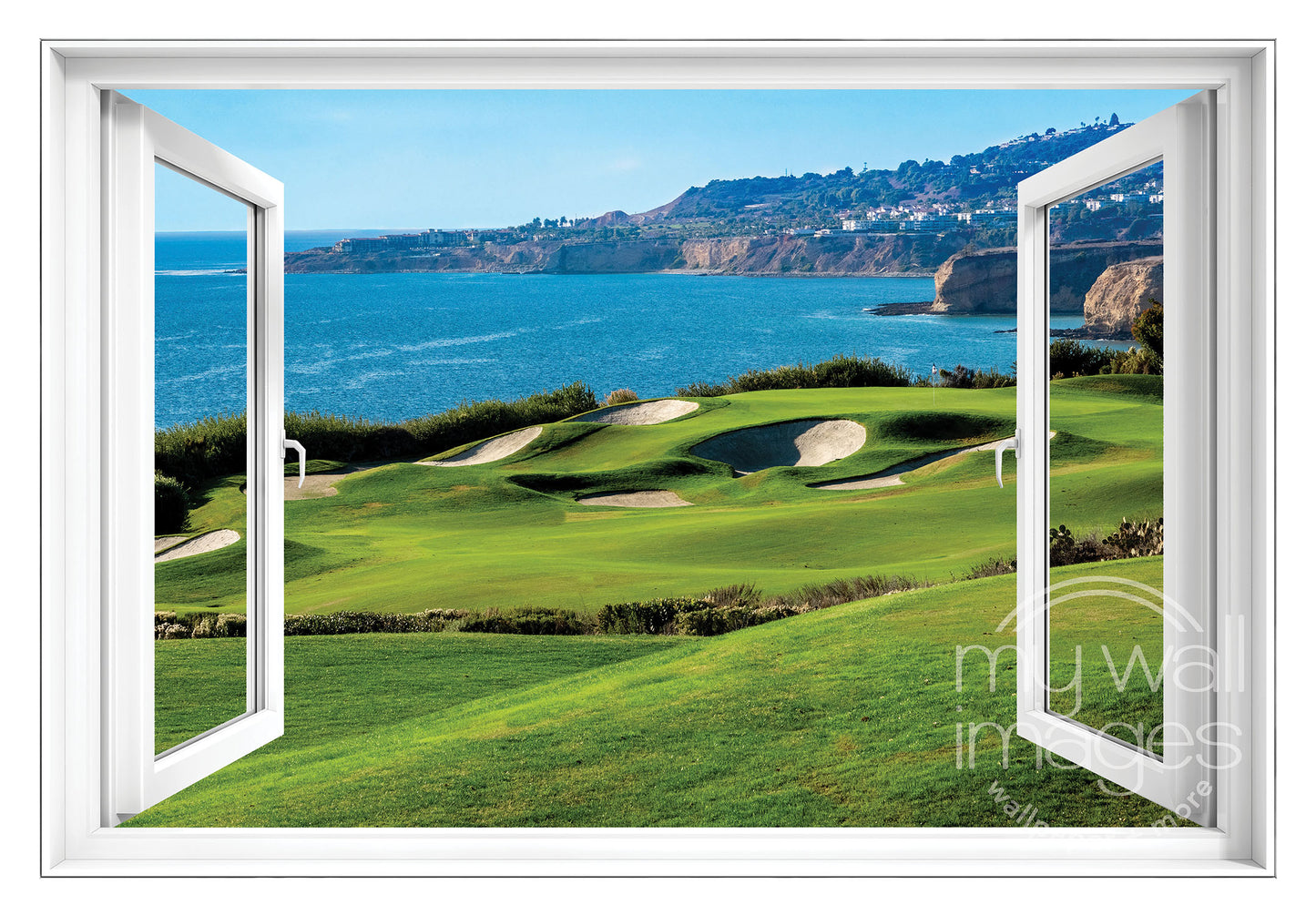 a scenic view of a golf course overlooking a body of water, with a clear blue sky above.