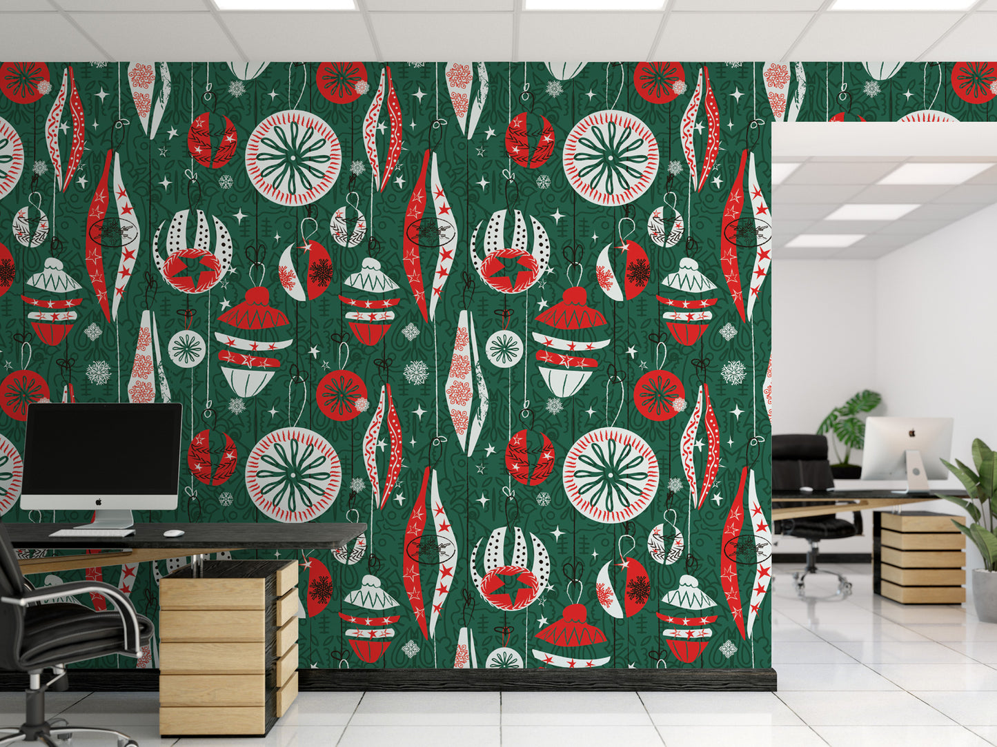 a modern office space with a large wall mural decorated with a repeating pattern of Christmas ornaments in red, green, and white colors. The office has a desk with a computer monitor, and there are potted plants and other decorative elements in the room.