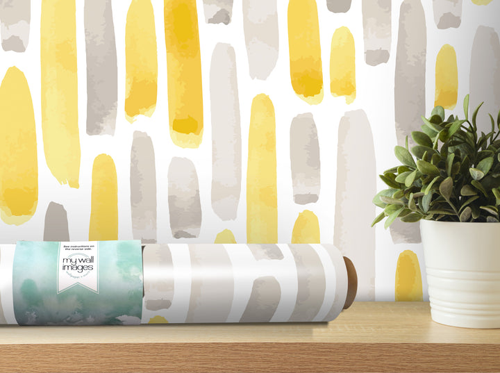 a wallpapered wall with a roll of wallpaper on a shelf next to a potted plant.
