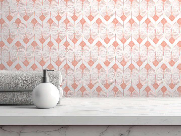 a white countertop with a white soap dispenser and a folded towel, set against a patterned wall with a repeating geometric design in shades of pink and white.