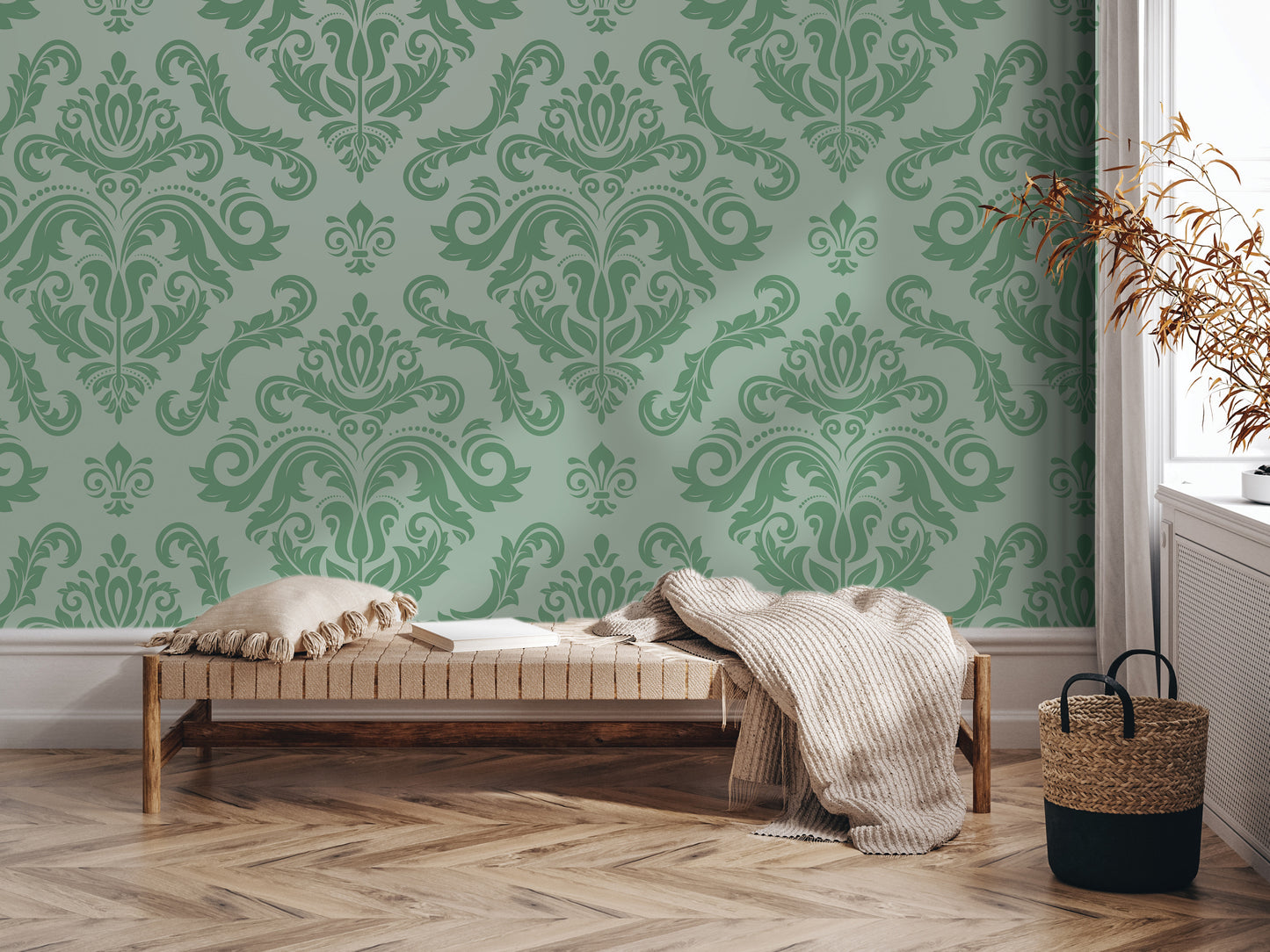 a cozy living room with a green and white damask wallpaper, a wooden bench with a blanket and pillows, and a woven basket on the floor.