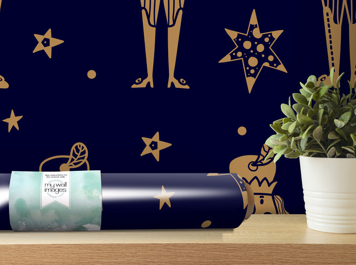 a blue wall with gold star and leaf designs, a potted plant, and a roll of wallpaper with a star and leaf design on it.