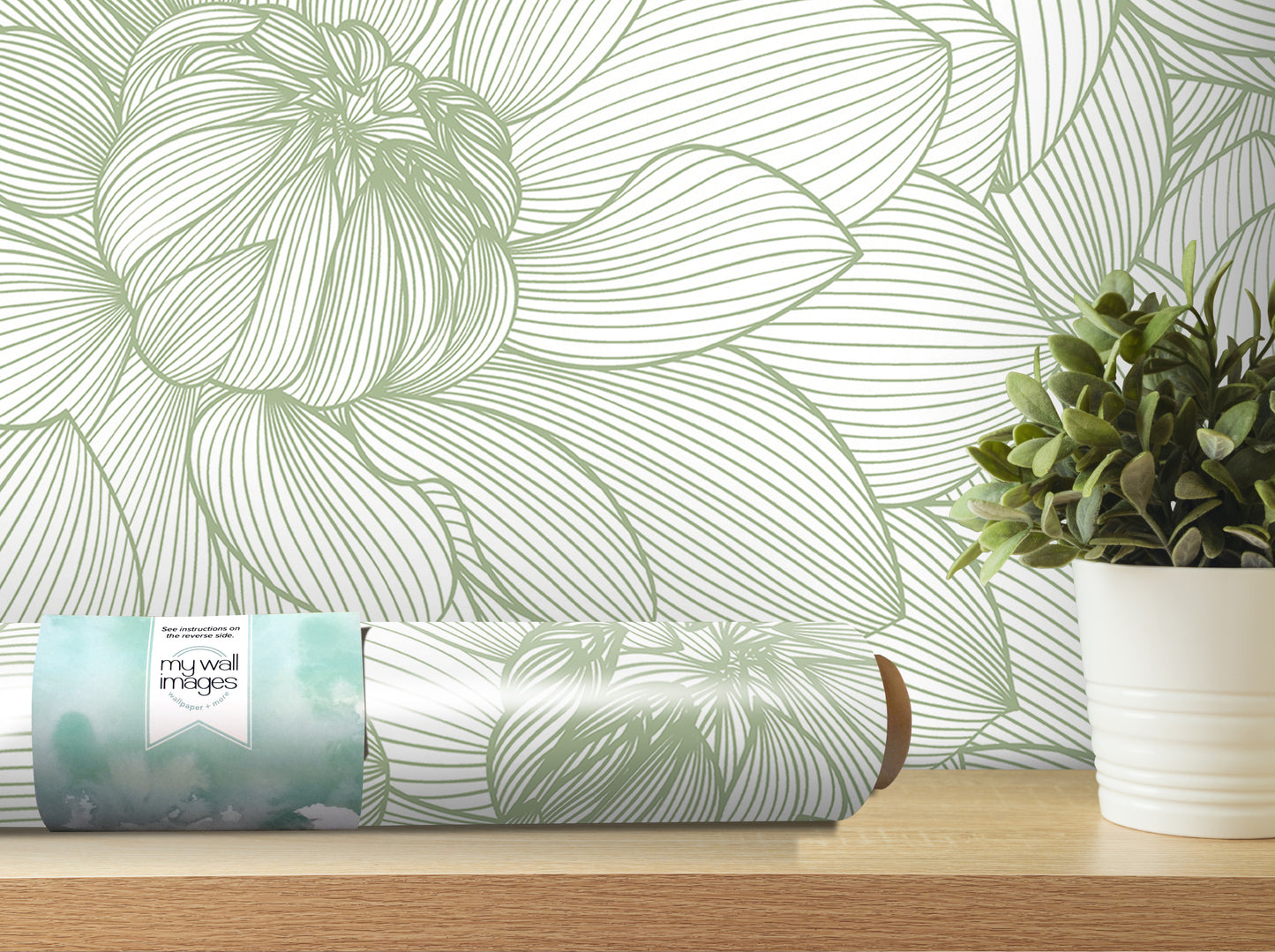 a wallpapered wall with a large green flower design, a roll of wallpaper, and a potted plant on a shelf.
