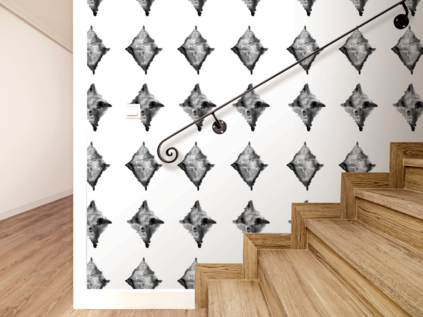 a staircase with a black metal handrail, and the wall behind it has a repeating pattern of diamond-shaped black and white designs.