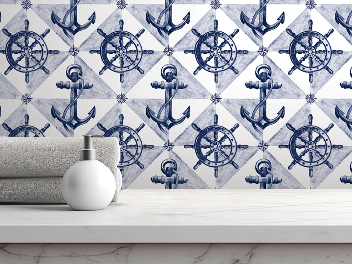 a white shelf with a white bottle and a gray towel, set against a backdrop of a repeating pattern of blue and white nautical-themed illustrations, including anchors, ship wheels, and steering wheels.