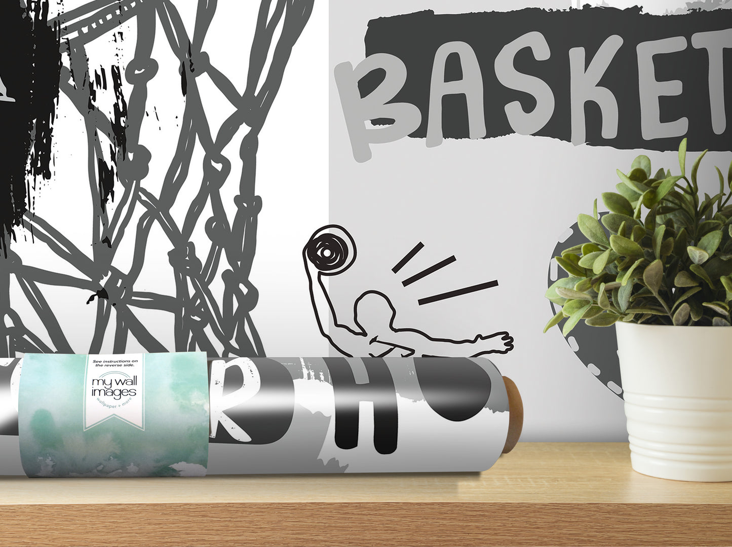 a wall with a basketball-themed design, including a basketball hoop and a basketball player. There is also a potted plant and a roll of wallpaper with a basketball design on it.