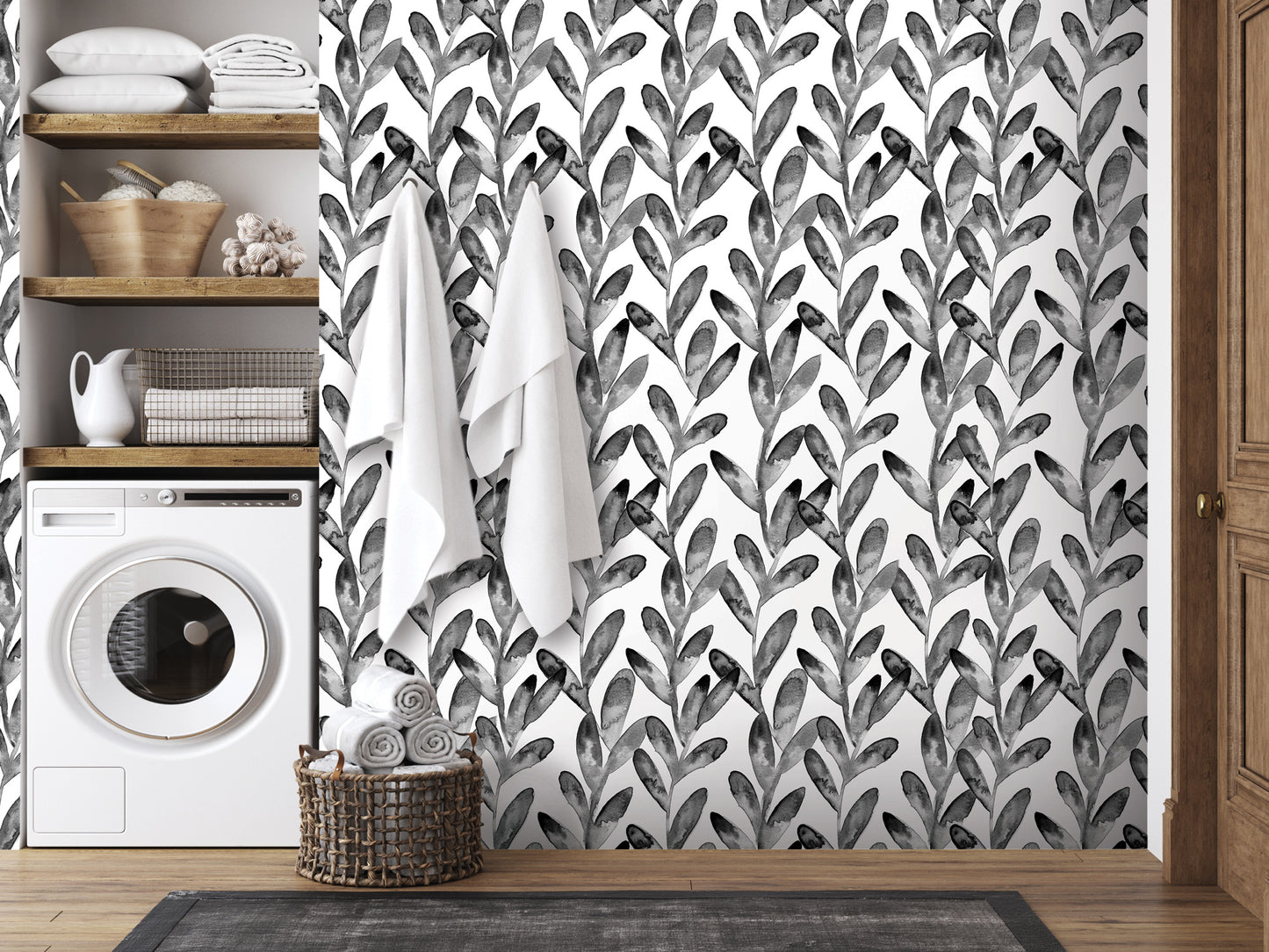 a bathroom with a black and white leaf-patterned wallpaper, a washing machine, and a basket of towels.