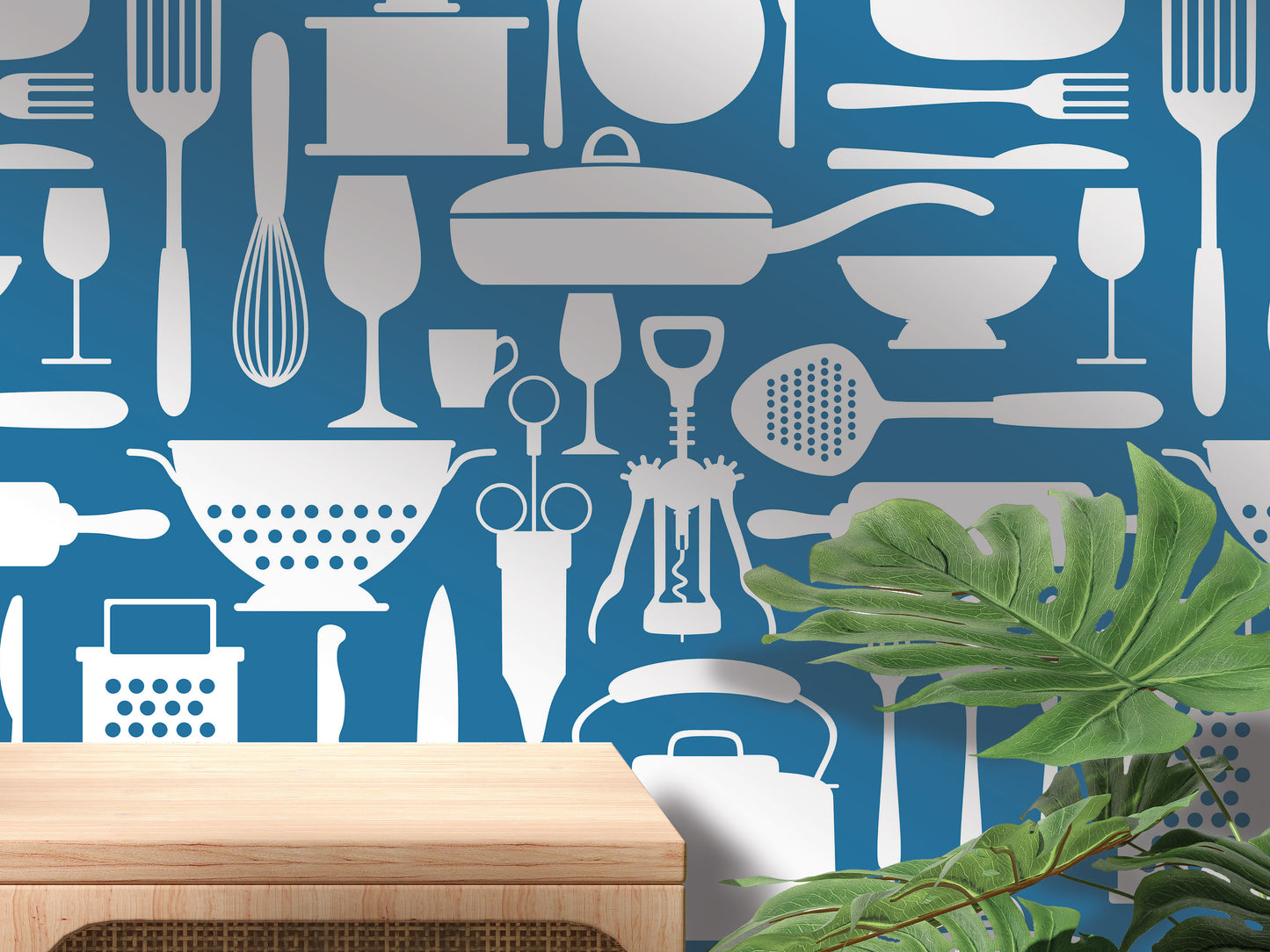 a wall with a repeating pattern of various kitchen utensils and appliances, including a variety of knives, spoons, bowls, and other cooking tools, all depicted in white against a blue background.