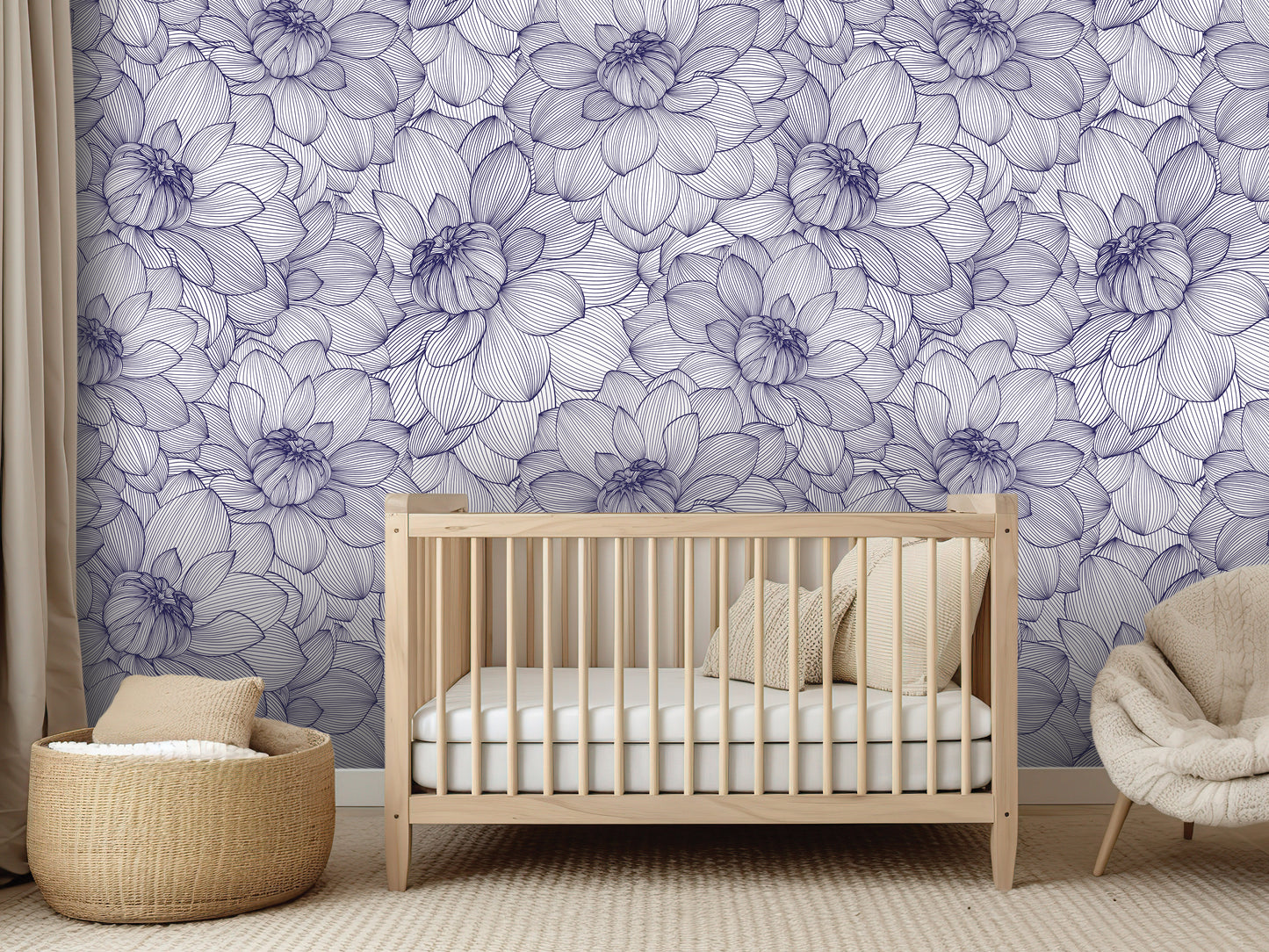 a nursery room with a wooden crib, a beige chair, and a woven basket. The walls are covered in a floral pattern in shades of blue and white.