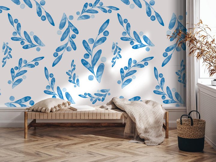 a room with a bed and a wall with blue leaves on it