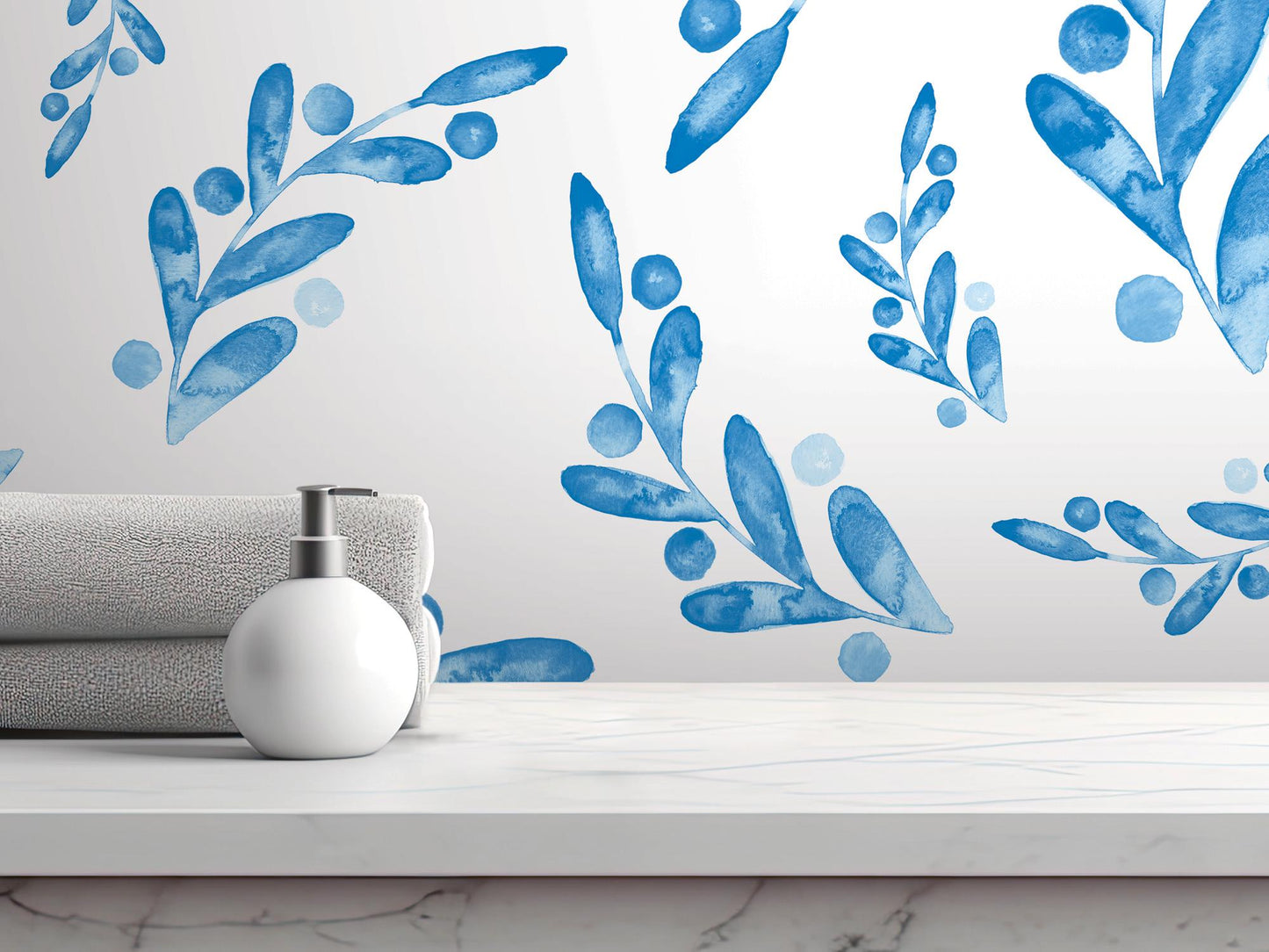 a white table topped with a white vase filled with blue flowers