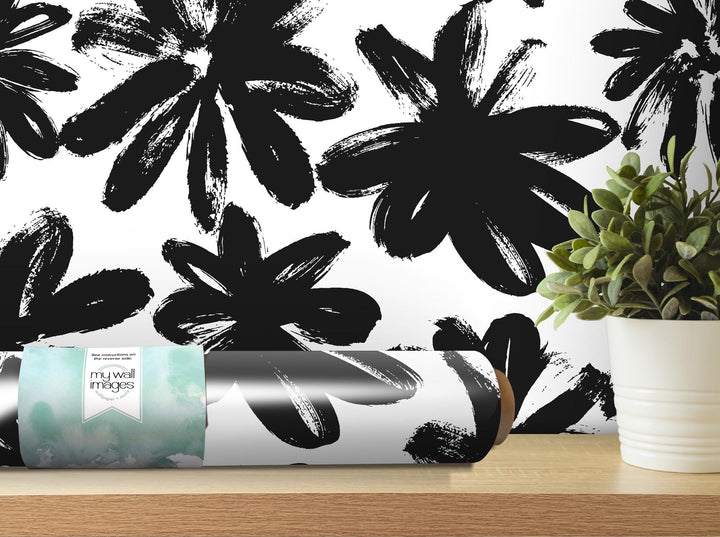 a black and white wallpaper with a vase of flowers