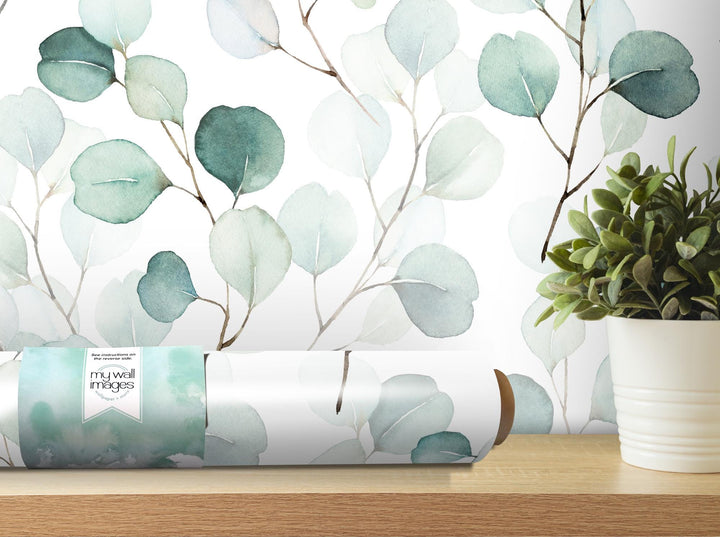a vase with a plant on top of a table