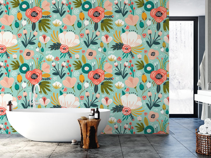 a bath tub sitting next to a wall covered in flowers