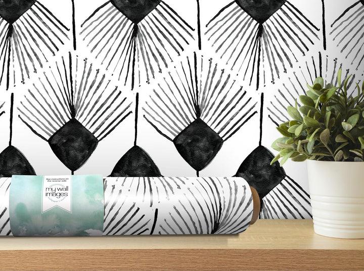 a black and white wallpaper with a plant in front of it